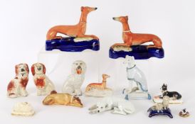 A selection of British and continental pottery and porcelain models of dogs