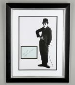 A green album card- signed in black in 'Best Wishes Charlie Chaplin'