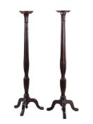 A pair of mahogany torchere stands in George III style