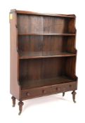 An early 20th century waterfall bookcase