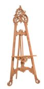 A carved and stripped softwood easel in Rococo taste
