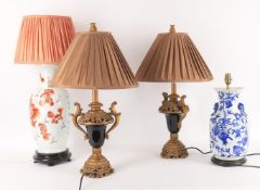 Lamps to include a pair of gilt wood mounted dark glass lamp bases
