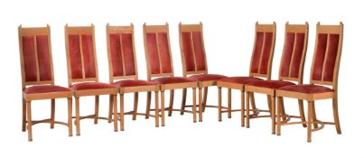 A set of eight walnut and suede style upholstered dining chairs