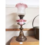 Edwardian brass based oil lamp with pink opaline vessel and pink flared shade all with floral