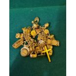 A huge 9ct gold charm bracelet featuring 37 individual charms, total weight 142 grams.