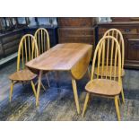 An Ercol light Windsor elmwood kitchen table and 4 chairs.