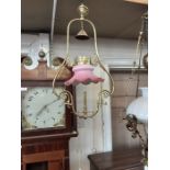 Victorian brass gas lamp lantern with pink frilled shade.