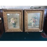 A pair of gilt framed floral still life prints.