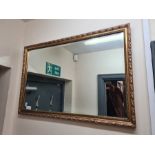 Large gilt framed bevel edged wall hanging mirror, 77cm x 52cm.