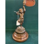 Victorian figural bronze lamp of a Putti holding a torch on turned wooden base.