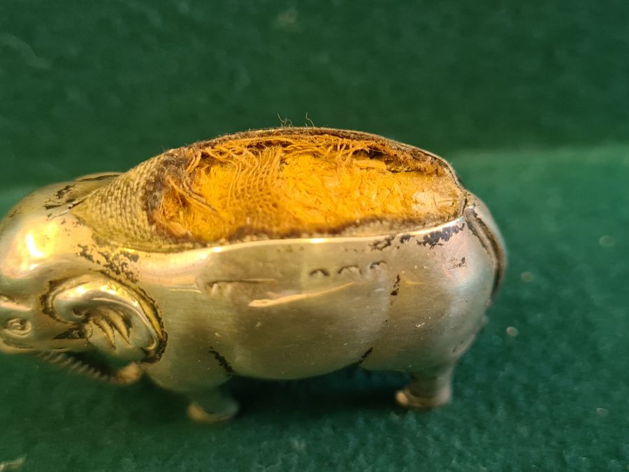 An early 20th century silver elephant pin cushion, marks indistinct, 4.50cm long. - Image 4 of 5