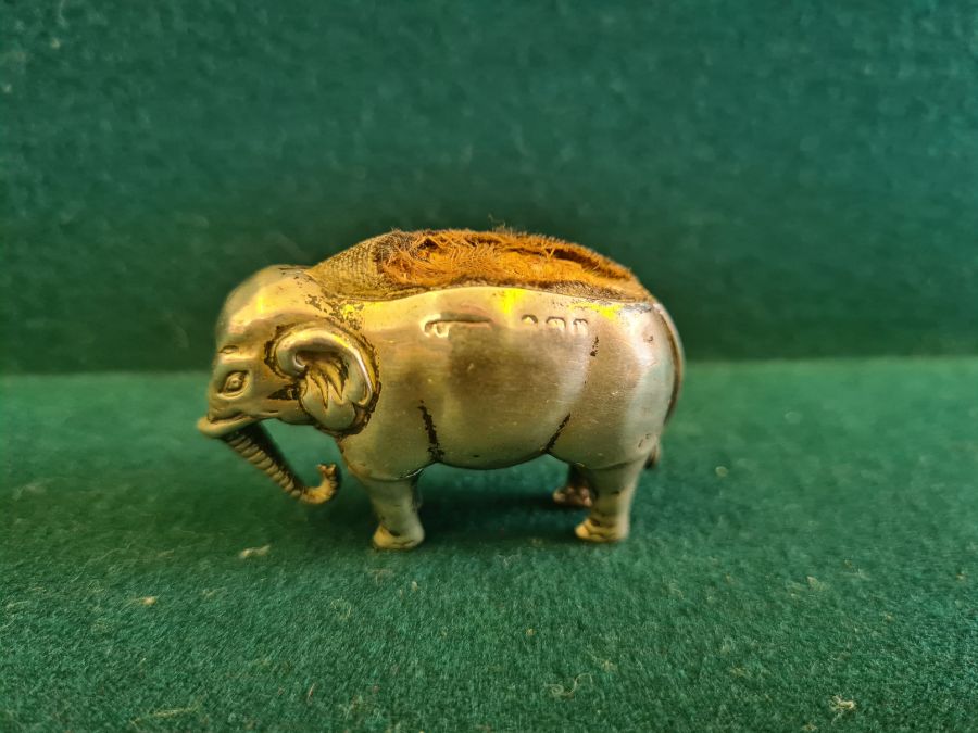 An early 20th century silver elephant pin cushion, marks indistinct, 4.50cm long.