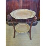 Indian carved folding 2 tier occasional table with 2 heavy brass trays.