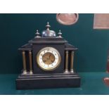 Victorian black slate mantle clock with brass column case, domed pediment with French striking