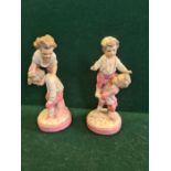 A pair of continental porcelain figures of young boys at play, marking entwined J.R. possibly