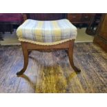 An American oak foot stool with splayed legs and gilt mounts with gilt touch carved rails.
