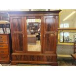 Large late Victorian 3 door flame veneer wardrobe with central mirror door upon bracket feet 3