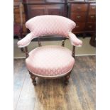Edwardian walnut tub chair with turned and reeded supports and front legs.