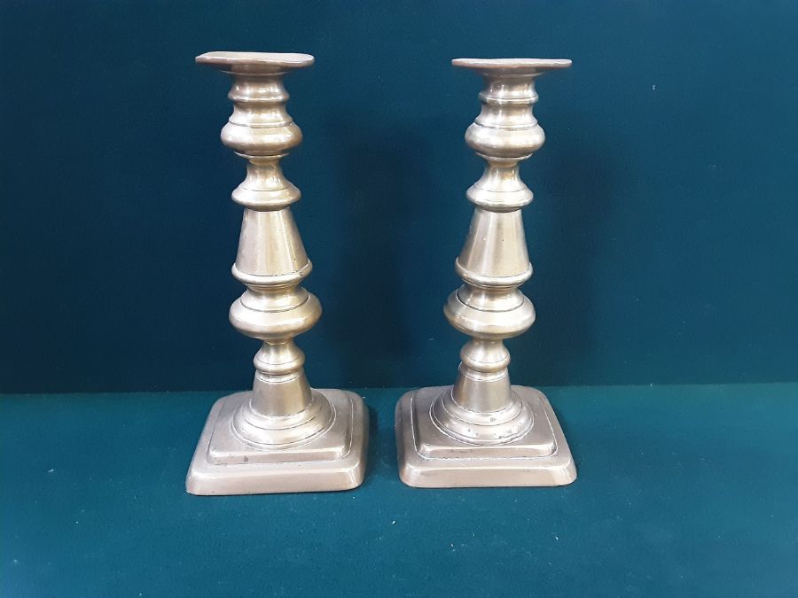 A pair of Victorian brass candlesticks standing 10" tall.