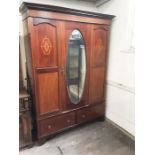 Late Victorian mahogany inlaid single mirror door wardrobe with twin drawer base.