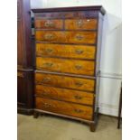 George III mahogany flame veneer 8 drawer tallboy with Greek key and dental pediment, later