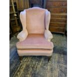 Large gentleman's wing back armchair upon 4 oak Queen Ann legs, reupholstered in a dusky pink
