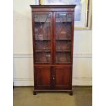 Georgian mahogany astragal glazed 4 door cupboard bookcase with ebony stringings upon bracket feet