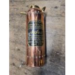 A vintage polished brass Safex fire extinguisher.