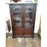 An oak Jaycee leaded door cupboard bookcase.