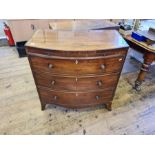 Regency mahogany bow fronted 3 drawer chest with crossbanded top and brushing slide upon splayed