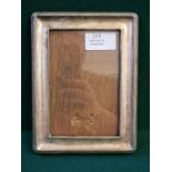 An Edwardian silver photo frame 17.5cm x 13cm with oak back board and rope edge decoration.