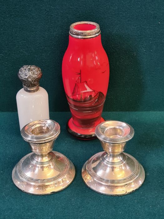 A pair of damaged silver stub candlesticks, a blown glass silver rim specimen vase and an unmarked