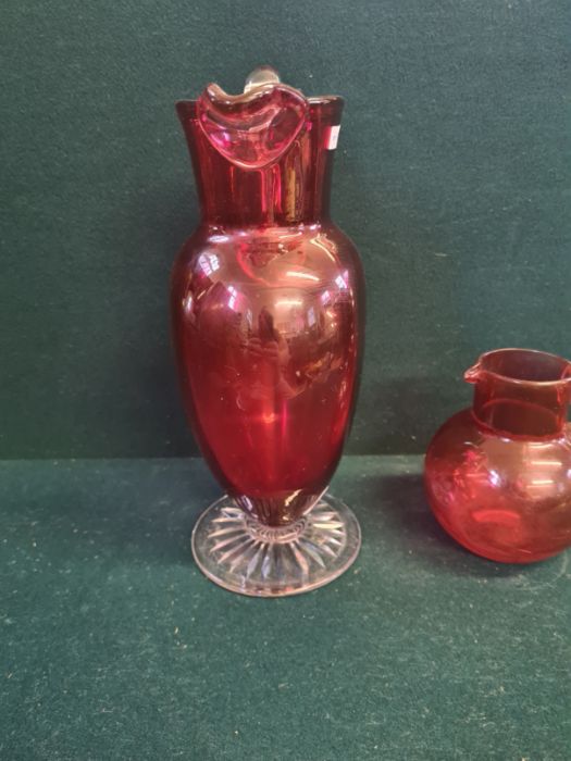 Large Victorian cranberry glass jug with clear cut foot standing 11" tall and a similar smaller - Image 4 of 5