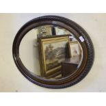 1930's oval bevel edged wall hanging mirror with rope and gadroon edging.