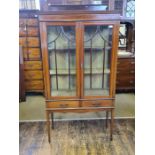 Edwardian Sheraton style inlaid china cabinet with 2 waisted drawers upon tall tapering legs,