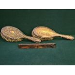 2 silver backed ladies hairbrushes decorated with ribbons and garlands and embossed flowers and
