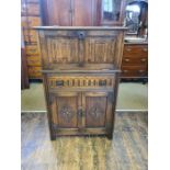 Jaycee linen fold decorated cocktail cabinet with carved lozenge lower doors.