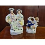 Staffordshire flat back figure, flower sellers and a spill vase of a Scottish couple.