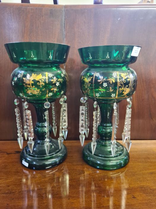 Pair of Victorian green gilt lustres standing approx. 22.5cm tall, slight chipping to top rims.