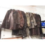 A collection of real and faux fur animal skin coats, jackets and stoles.
