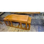 Set of mid century teak nesting tables with flip top coffee table.