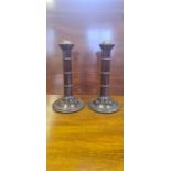 A pair of Victorian turned mahogany gun barrel candlesticks, 29cm tall.