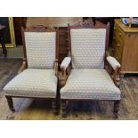 Pair of Edwardian oak armchairs with scrolled reided and carved decoration, broken arch top rails