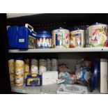 2 shelves of Tetley tea collectables to include lunch boxes, biscuit barrels, biscuit tubes, die