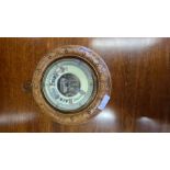 Carved cased early 20th century aneroid barometer.