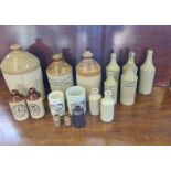 A large quantity of vintage stoneware bottles and flagons, glass bottles to include I. Gunson,