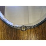 Brass framed bevel edged oval wall hanging mirror.