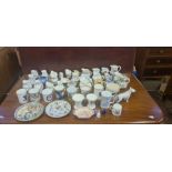 2 trays of assorted decorative china jugs and assorted pottery and porcelain beakers.