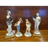 A pair of Italian porcelain figures of a young shepherdess and a farm boy together with a pair of