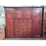 Early Victorian mahogany inverted break front flame veneer wardrobe with 6 cock beaded drawers